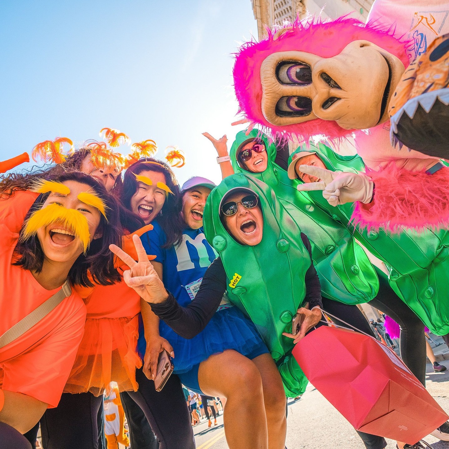 Friends posing together in colorful costumes